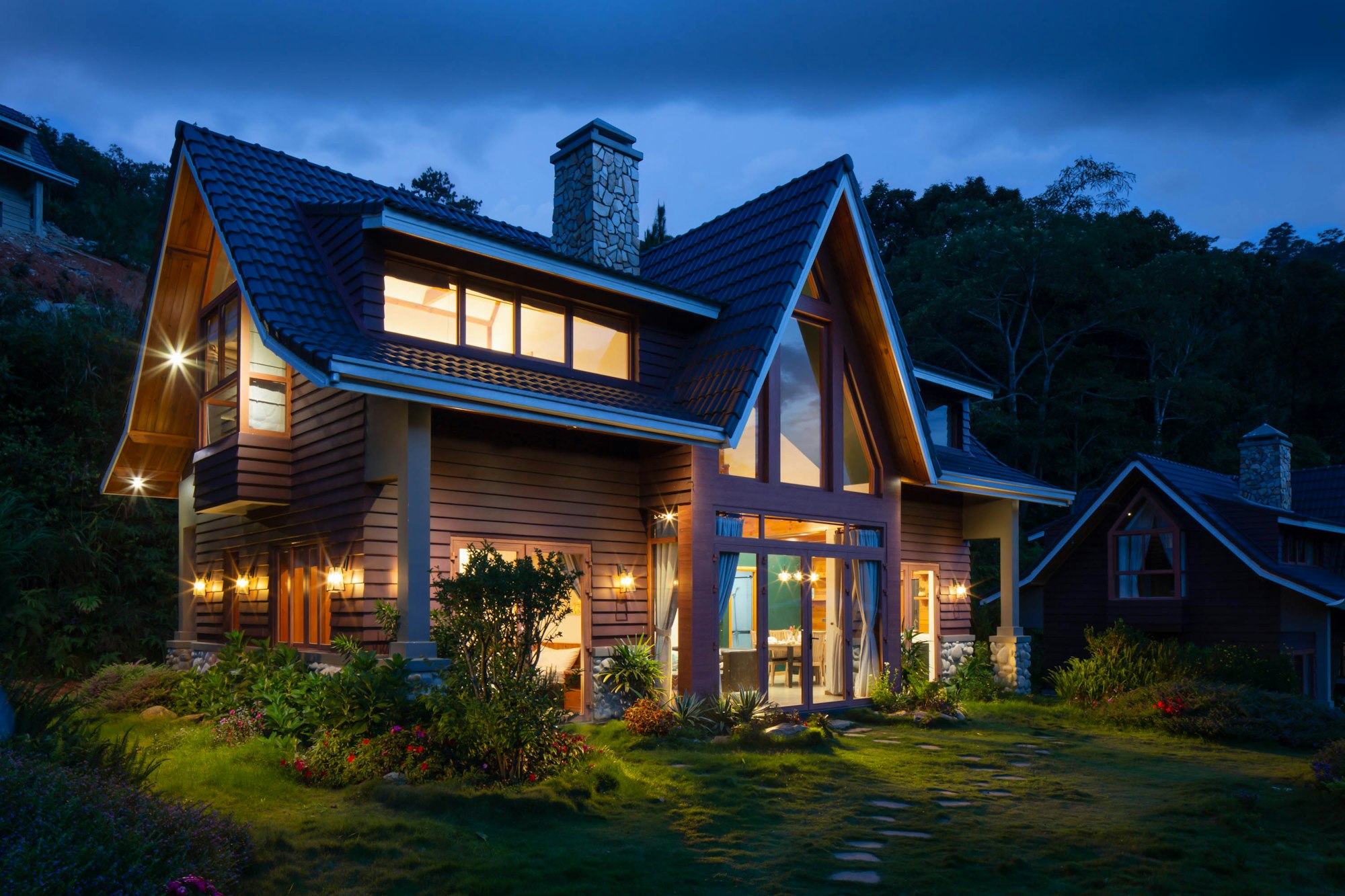 Timber lodge home glowing at dusk